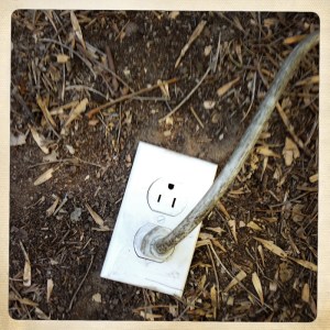 Photo of an electrical outlet in the ground.