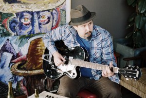 James Slay of Dumfuxx plays guitar at a Dumfuxx rehearsal.