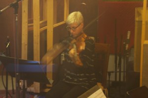 Photo of Lauren Chipman playing viola at Little Box Studios for the Dumfuxx score to "Asphalt Serenade".